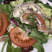 Greek Salad · Mixed Greens, tomatoes, cucumbers, red onions, Kalamata olives, dolmadakia, feta cheese, oli...