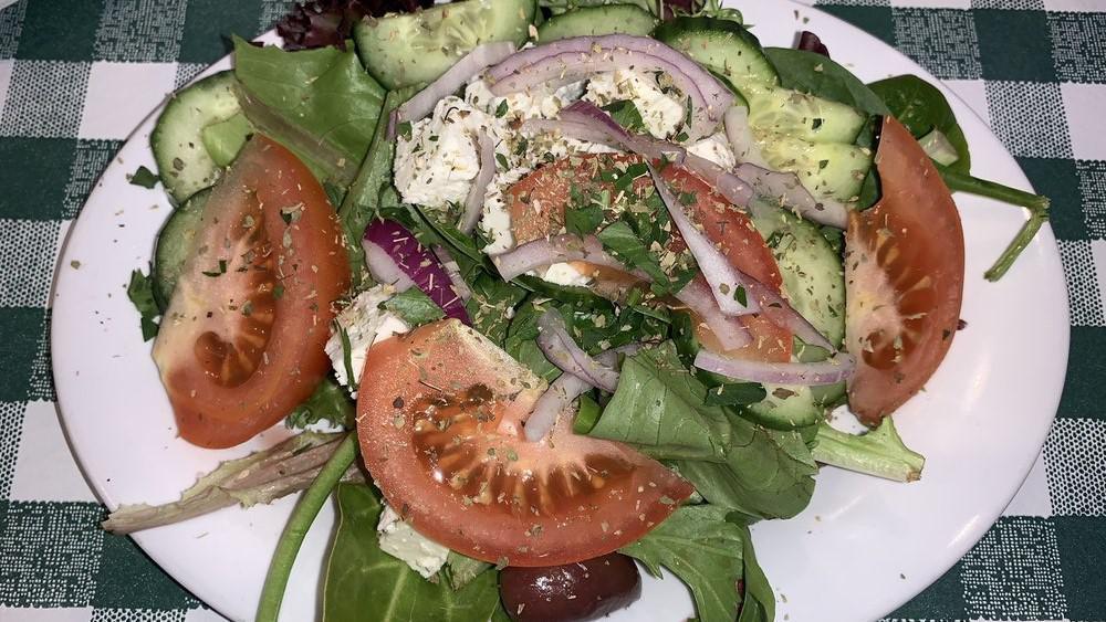 Greek Salad · Mixed Greens, tomatoes, cucumbers, red onions, Kalamata olives, dolmadakia, feta cheese, olive oil and oregano.