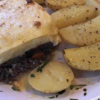 Moussaka · Traditional Greek dish consisting layers of eggplant, ground beef and bechamel sauce