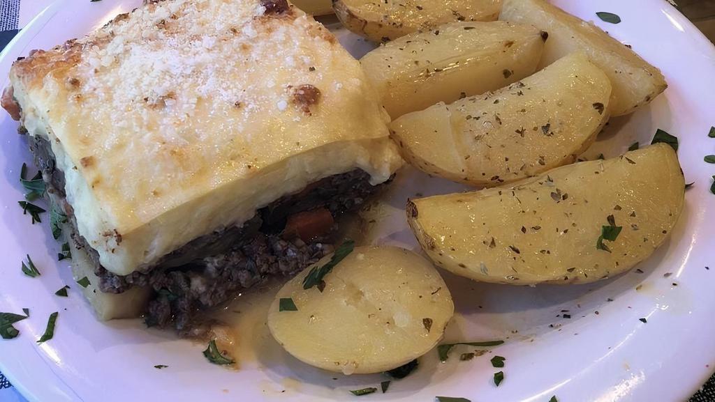Moussaka · Traditional Greek dish consisting layers of eggplant, ground beef and bechamel sauce