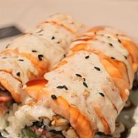 Baked Salmon Roll · Crab, avocado, cucumber topped with baked salmon sweet sauce, pineapple, and mango sauce.