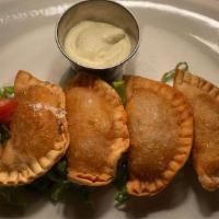 Empanaditas De Espinaca Y Requeson · Deep fried, filled with spinach and spanish style ricotta cheese.