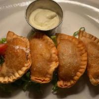 Empanaditas De Tinga · Deep fried, filled with shredded chicken and cheese, served with chipotle aioli.