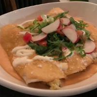 Enchiladas Mariscos · Gulf shrimp, lump crab, sauteed cabbage, queso cotija, shrimp tequila salsa.