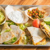 Quesadillas · 9'' in a flour tortilla, filled with Pepper Jack and Cheddar cheese, topped with guacamole, ...