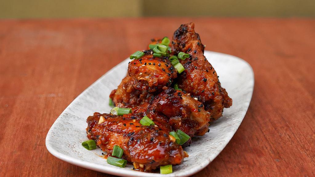 House Crispy Wings · Crispy wings tossed in house sweet & sour soy chili sauce, scallion, minced garlic, sesame seeds.