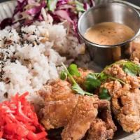 Kara Age Fried Chicken Bowl · Served over hot rice, spicy mayonnaise, scallions, cilantro, seven spice, and house slaw.