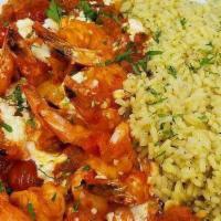 Shrimp Ouzo Santorini · Gluten-free. Sautéed shrimp in a light tomato ouzo sauce, topped with feta cheese & served o...