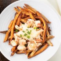 Lobster Poutine · Hand-cut fries, butter poached lobster, bechamel, and shaved Parmesan.