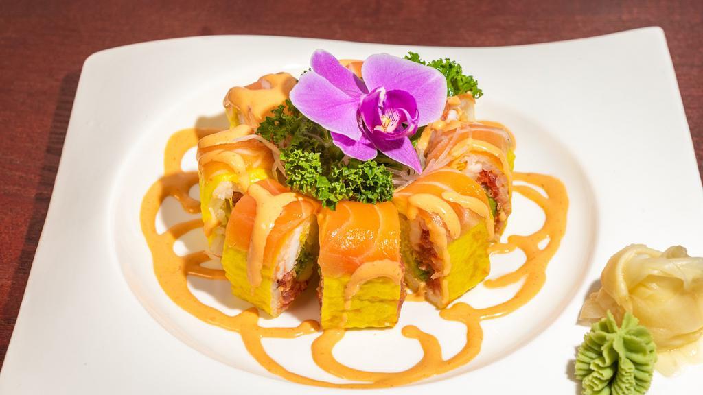 Tokyo Roll · Spicy tuna shrimp, avocado and tempura flakes topped with salmon and spicy mayo wrapped in soy paper.