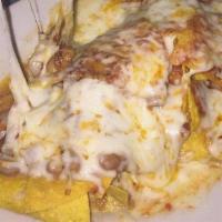 Nachos Grande (Al Rey) · Tortilla chips topped with refried beans, ranchera & enchilada sauce, melted cheese, served ...
