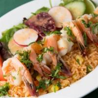 Garlic Shrimp · Shrimp marinated in garlic sauce served on a bed of rice with salad.