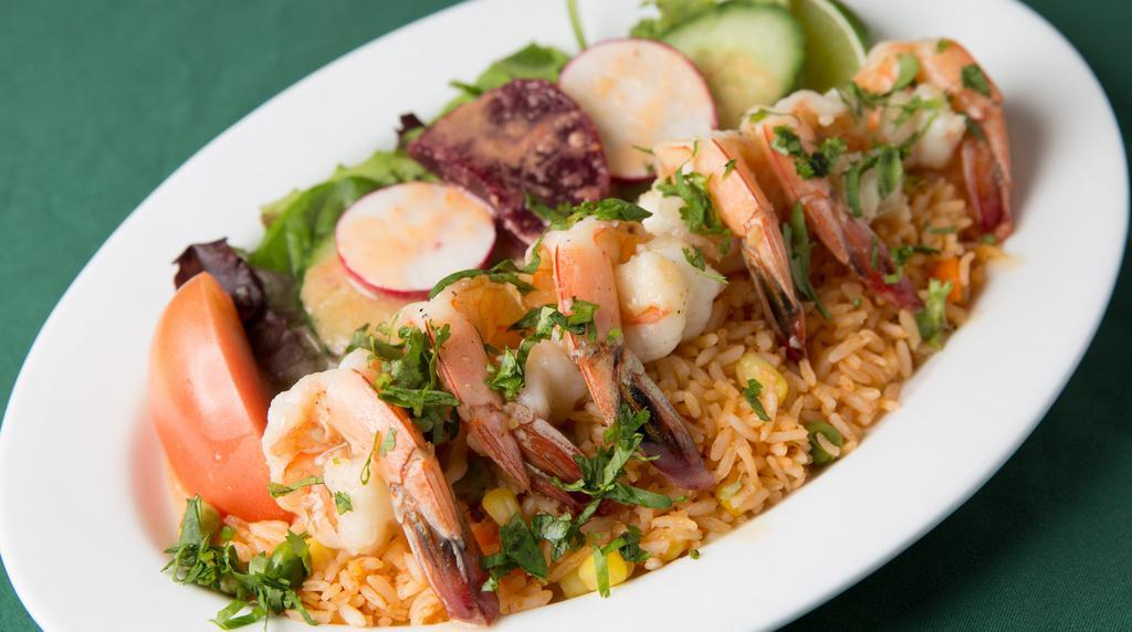 Garlic Shrimp · Shrimp marinated in garlic sauce served on a bed of rice with salad.