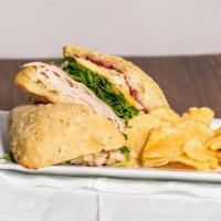 Golden Brie Gobbler · Turkey, creamy brie cheese, thinly sliced apple and arugula with cranberry mayo sauce.