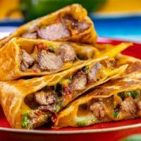 Steak & Eggs Quesadilla · Grilled flour tortilla filled with melted cheese, savory steak, and eggs. Served with a side...