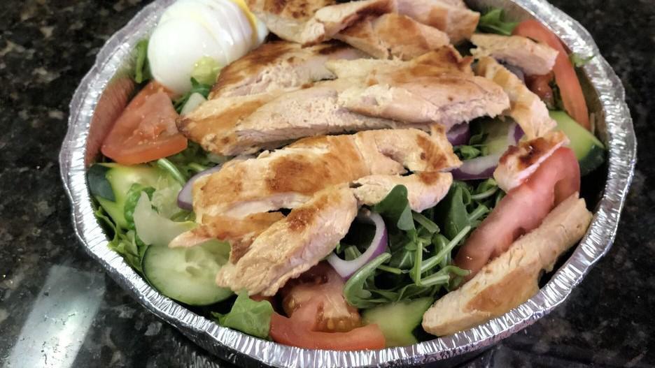 Cobb Salad · 588 calories. Mixed greens, grilled chicken, bacon, tomato, avocado, cucumbers, red onions, hard boiled egg and choice of dressing.