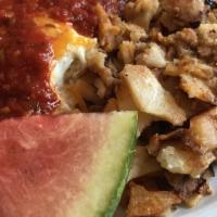 Huevos Rancheros · Fried eggs, tortillas, cheddar, rancheros sauce served with homefries