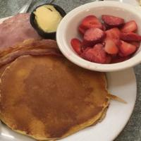 Griddle Deluxe · Pancakes, waffles or french Toast with bacon, ham and sausage, two eggs.