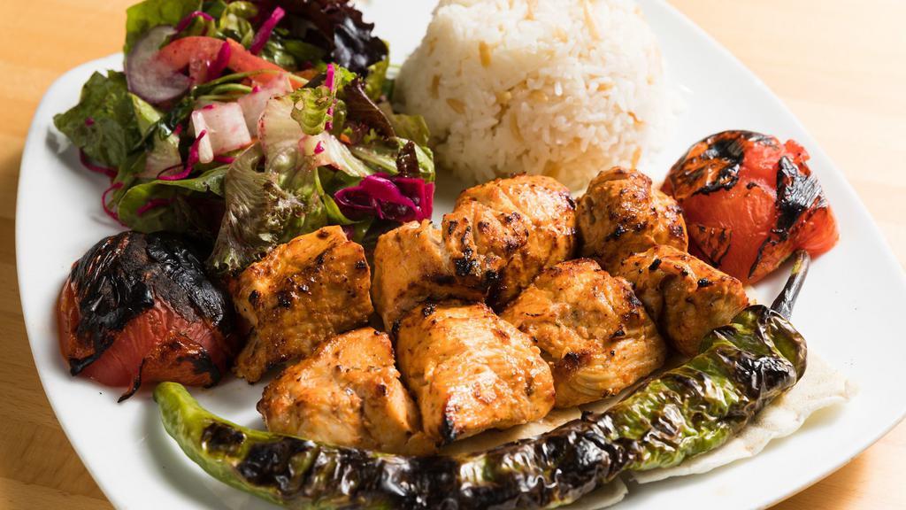 Chicken Shish Kebab · Tender chunks of chicken marinated with chef's own blend and herbs served with salad and rice.