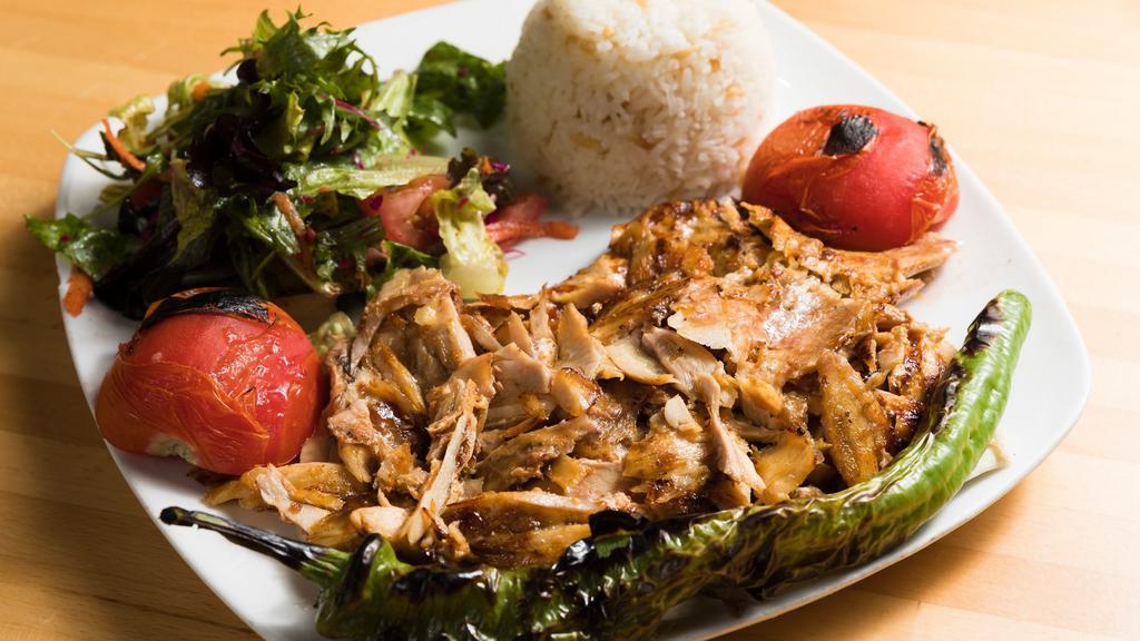 Chicken Gyro (Tavuk Doner) · Layers of marinated chicken thighs wrapped around the large vertical split and grilled in front of charcoal fire. Served with rice and salad.