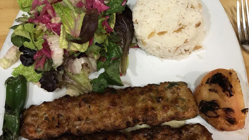 Chicken Adana Kebab · Ground chicken flavored with red bell peppers, parsley and grilled on skewers served with salad and rice.