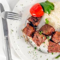 Beef Shish Kebab · Cubes of beef marinated in chef's special sauce and grill on skewers served with rice and sa...