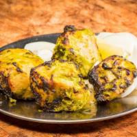 Achari Chicken Roll · Chunks of chicken cooking in a spicy achar mango pickle sauce.