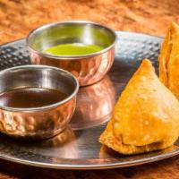 Samosa (Veg) · Vegetarian. 2 pieces. Fried fritters stuffed with spiced potatoes, green peas and onions ser...