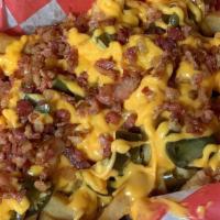 Loaded Fries · Covered in Cheese Bacon & Jalapenos.