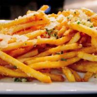 Truffle Fries · Shoe-string fries seasoned with truffle oil, shaved Parmesan, chicharron, and herbs.