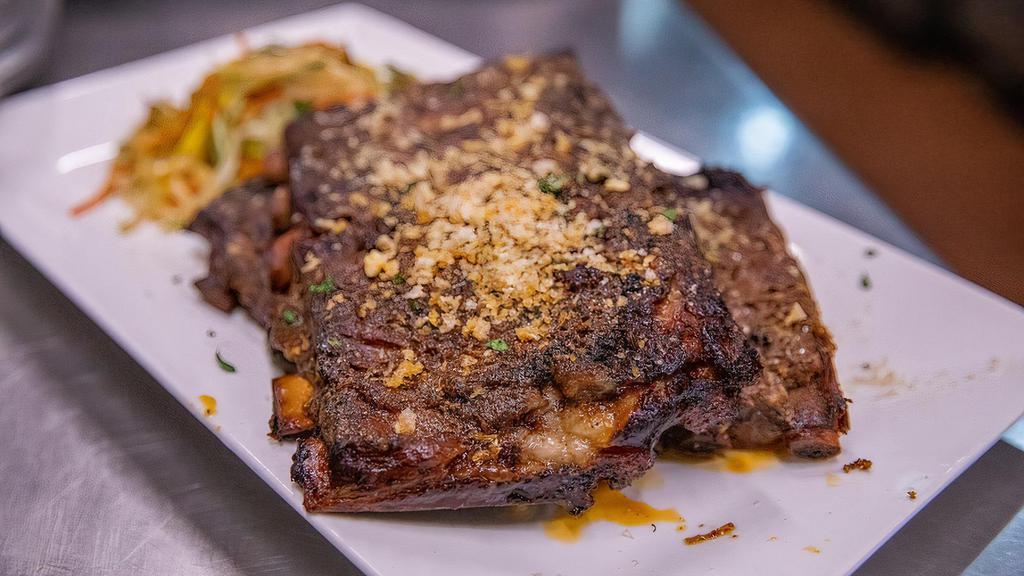 Full Rack Of Ribs · Full Rack of our famous dry rub marinaded ribs served with Asian slaw