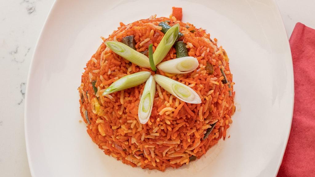 Vegetable Schezwan Fried Rice · Stir-fried rice mixed with vegetables seasoned with hot and spicy sauce bursting with ginger, garlic and chili.
