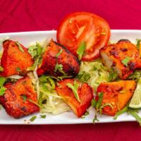 Chicken Tikka (Grilled Appetizer) · Tender pieces of chicken marinated in yogurt and spices.