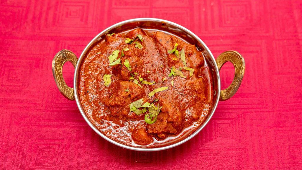 Lamb Vindaloo · Cooked with fiery red chilies, spices and a touch of vinegar to create our hottest dish. Served with basmati rice.