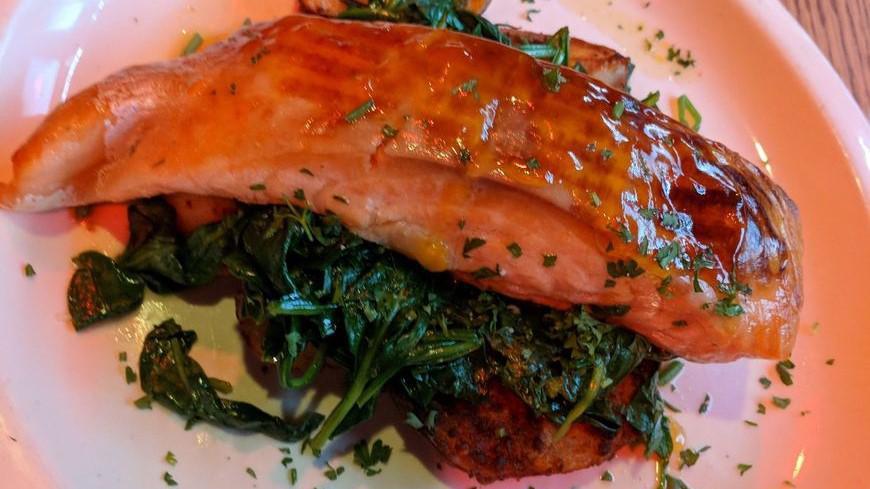 Apricot Glazed Salmon · Fresh Norwegian salmon grilled to perfection, topped with an apricot glaze accompanied with sauteed spinach and brick oven roasted potatoes.