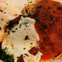 Veal Parmigiana · Tender cutlets of veal topped with fresh mozzarella and our smooth marinara sauce served wit...