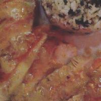 Pollo Con Sabor · Grilled chicken breast served with coconut mojo sauce and cilantro rice