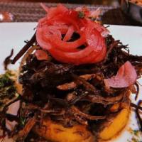 Vaca Frita ( De Pollo) · Shredded fried chicken breast with onions, served with maduros & moro rice