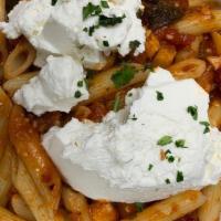 Pasta Melanzane · Diced eggplant in a plum tomato sauce with a dollop of fresh ricotta.