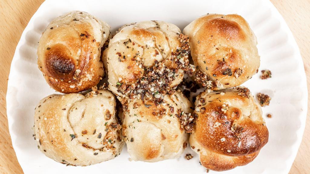 Garlic Knots Catering · A classic snack, our garlic knots are strips of pizza dough tied in a knot, baked, and then topped with melted butter, garlic, and parsley. Supersized for your party.