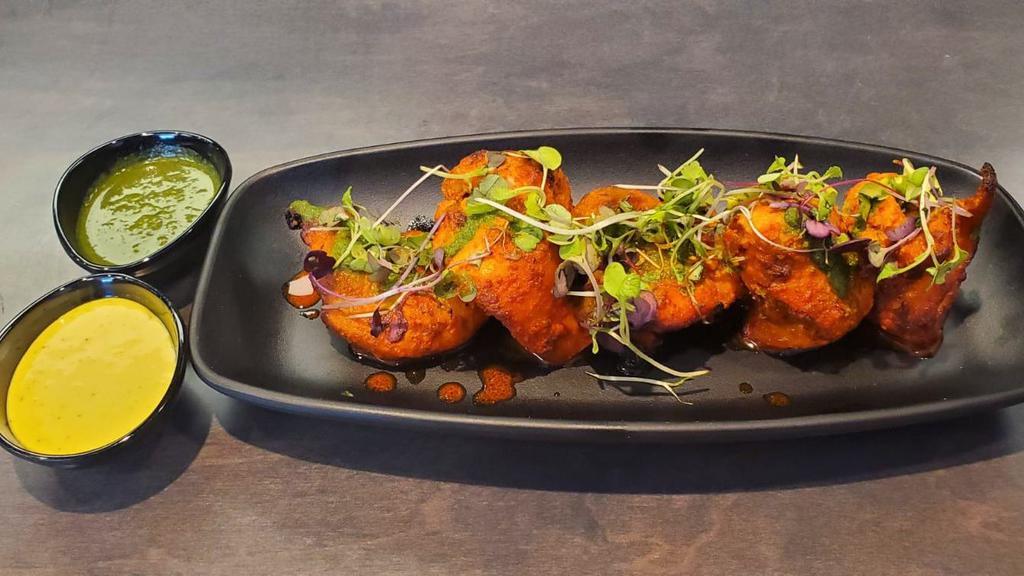 Tandoori Chicken · Chicken thigh marinated with indian spices and cooked in tandoor oven served with mint chutney.