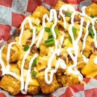 Loaded Tots  · Loaded with whiz, bacon, green onions and sour cream drizzled on top.