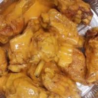 Regular Buffalo Wings · Chicken wings breaded and fried, then tossed in buffalo sauce.