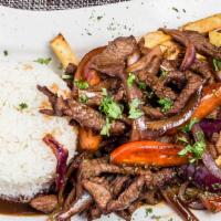 Lomo Saltado · Peruvian-style beef stir-fried sautéed with onions, tomato, French fries and our mind-blowin...