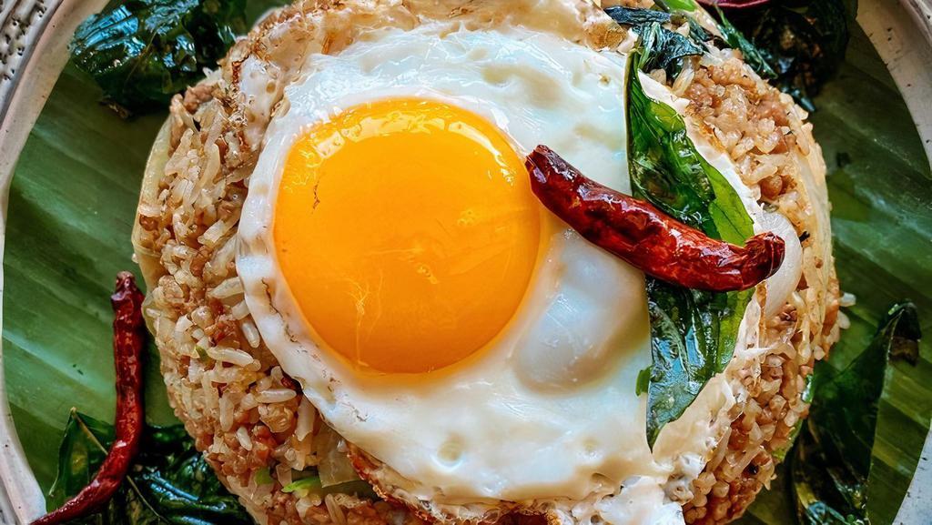 Khao Klook Kaprow Khai Dow (Basil Fried Rice) · Spicy. Traditional Thai basil fried rice with garlic, chili, onion, long hot pepper, and basil, topped with fried egg and crispy fried chili.