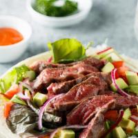 Mexican Steak Salad · Fresh Salad made with Beef steak, mixed greens, avocado, corn, black beans, tomatoes and bal...