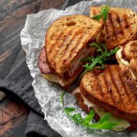 Monte Cristo Panini · Fresh Panini made with Turkey and ham, lettuce, tomatoes, Muenster cheese, and Russian dress...