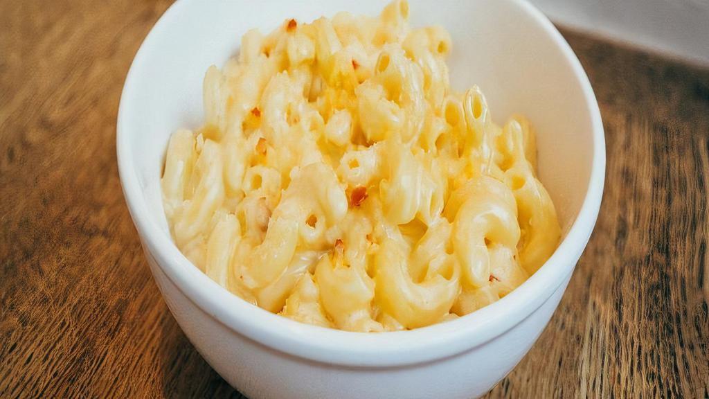 Mac And Cheese · A mixed of three kinds of cheese; parmesan, gooda and mozzarella, salt and  with a touch of milk.