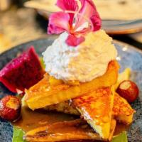 Tres Leches French Toast · Artisanal brioche bread, caramel rum sauce, local seasonal fruit, house seasonal whipped cre...