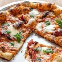 Margherita Pizza · Fresh mozzarella, Parmesan, charred San Marzano tomatoes.